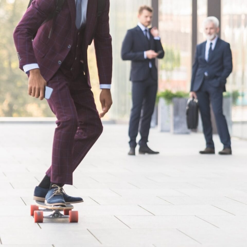 Businessman Standing On Skateboard